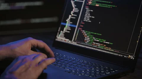 Programmer's hands and laptop keyboard close-up. Working on a project on a Stock Footage 180024582