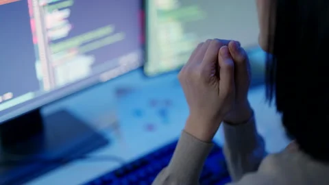 A programmer's hands are poised for action, blurred in motion against the bac Stock Footage 310589060