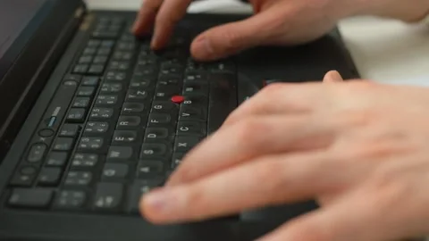 The programmer's hands are pressing the buttons of the computer. Stock Footage 153616059