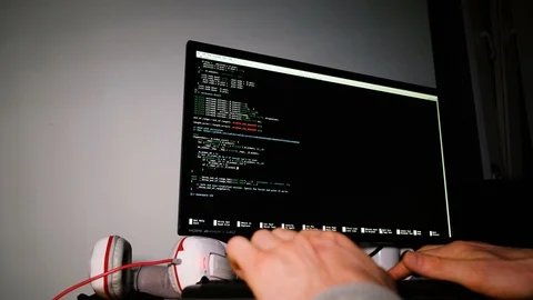 Programmers hands typing on the keyboard, the command line on a computer monitor Stock Footage 99328101