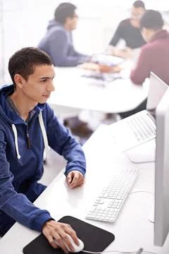 Programmers make the world better one code at a time. a young man working on his Stock Photos