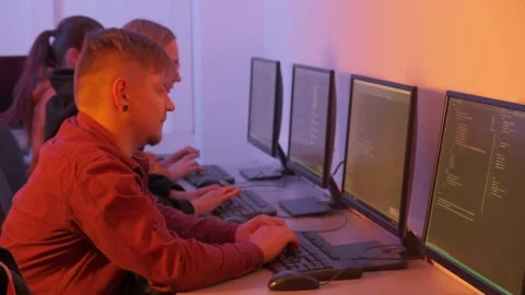 Programmers a man and three women get to work and quickly type on the keyboard. Stock-Footage 146813036