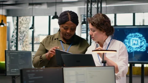 Programmers in office automating workflows using artificial intelligence tech Stock Footage 323238603