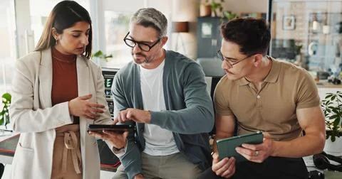 Programmers, people and tablet in office for help, advice and problem solving in Stock Photos