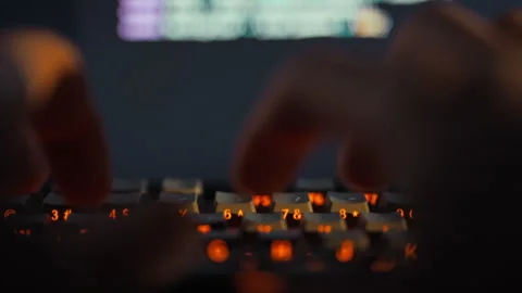 A programmers skilled hands swiftly type complex code on a computer keyboard Stock Footage 331458988