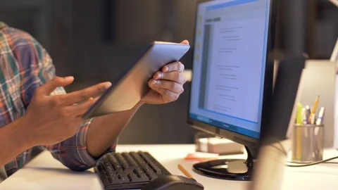 Programmers with tablet pc working at night office Stock Footage 88048168