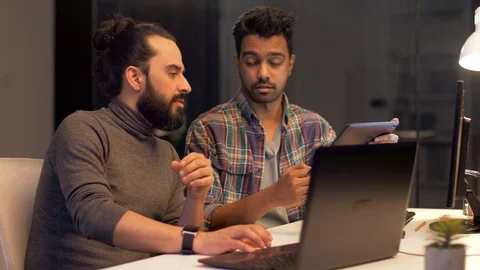 Programmers with tablet pc working at night office Video stock 88145235