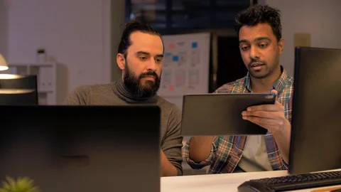 Programmers with tablet pc working at night office Video stock 88146205