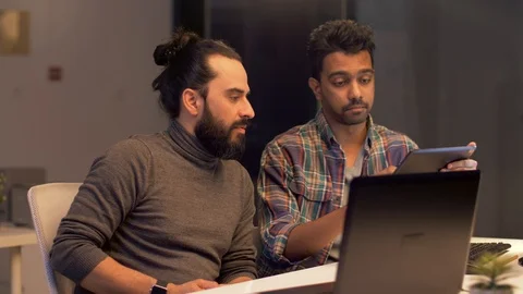 Programmers with tablet pc working at night office Stock-Footage 88354412