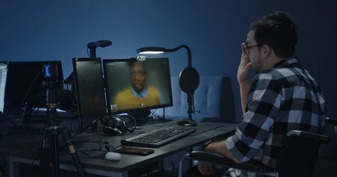 Programmers talking via a VoIP call Stock Footage 125171702