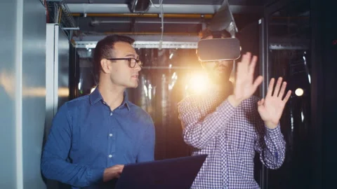 Programmers use VR equipment in a server room, close up. Stock Footage 98582848