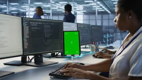 Programmers using isolated screen tablet in server room Stock-Fotos