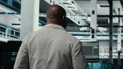Programmers walking in data center coding, doing optimizations using tablet Video stock 311832610