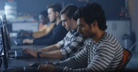 Programmers working and one turning to the camera Stock Footage 125172279