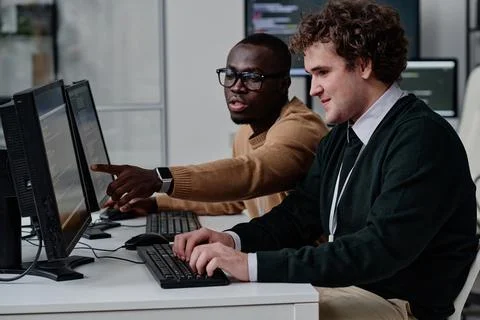 Programmers working with computer program in team Stock Photos