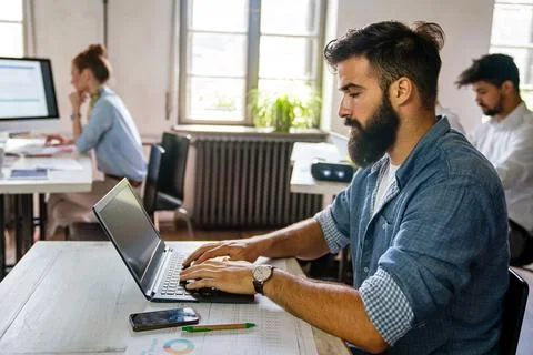Programmers working in a software developing company office. Business people as Stock Photos