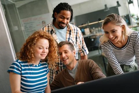Programmers working in a software developing company office Stock Photos