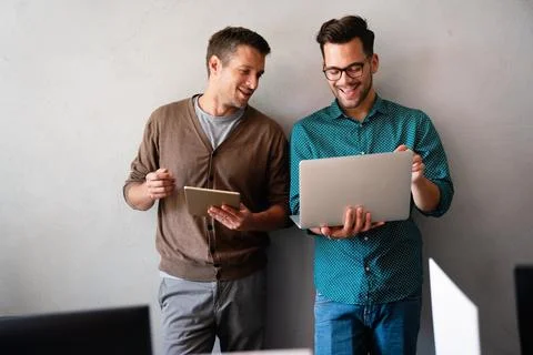 Programmers working in a software developing company office Stock Photos