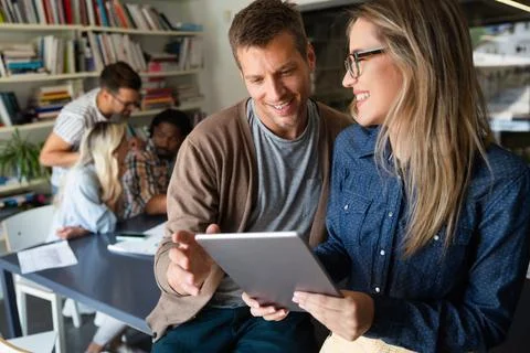 Programmers working in a software developing company office Stock Photos