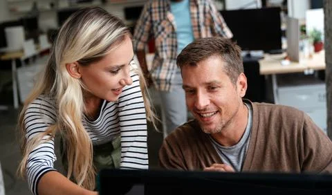 Programmers working in a software developing company office Stock Photos