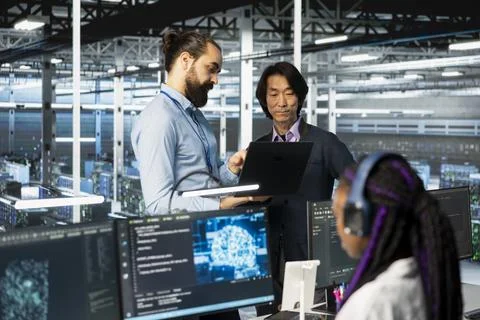 Programmers working together, coding in data center, updating deep learning Stock Photos