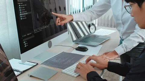 Programmers Working Together on Computer Code Video stock 305682189