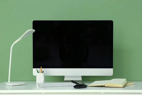 Programmers workplace with blank computer monitor near green wall in office 스톡 사진