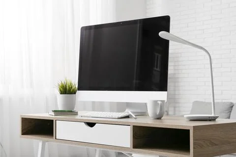 Programmer's workplace with blank computer monitor and lamp in office Stock Photos