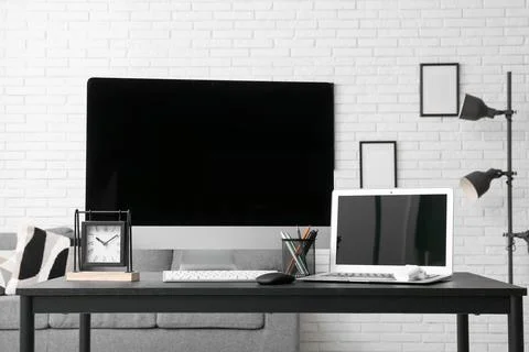 Programmer's workplace with blank laptop and computer in office Stock Photos