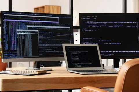 Programmer's workplace with gadgets near folding screen in office Stock Photos