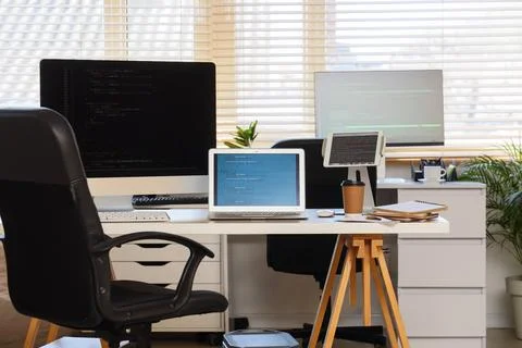 Programmers workplace with gadgets in office Stock-Fotos
