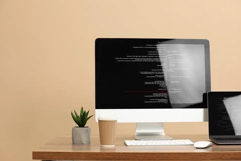 Programmer's workplace. Modern computer with unfinished code, laptop and ot.. 写真素材