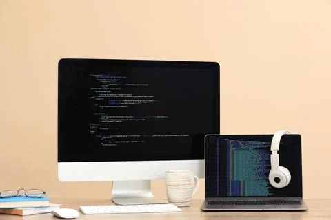 Programmer's workplace. Modern computer with unfinished code, laptop and ot.. 스톡 사진