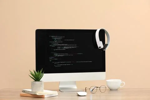 Programmer's workplace. Modern computer with unfinished code on desk Foto stock