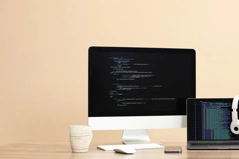 Programmer's workplace. Modern computer with unfinished code, laptop and ot.. 写真素材