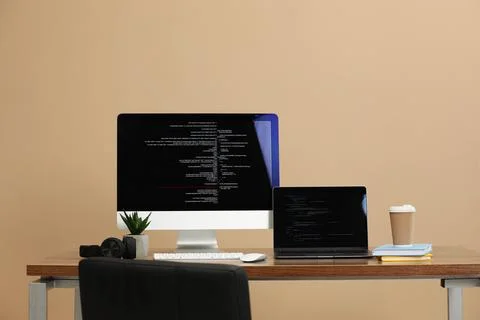 Programmer's workplace. Modern computer with unfinished code, laptop and ot.. Foto stock