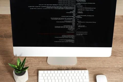 Programmer's workplace. Modern computer with unfinished code on desk, above.. Stock Photos