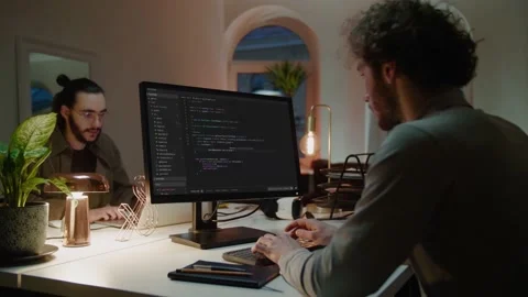 Programmers write codes on computers in semi-dark office Stock Footage 150396685