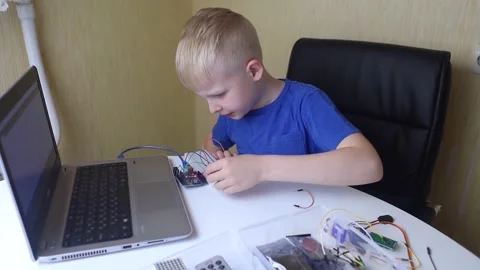 Programming for children. The boy is studying online at a robotics school for pr Stock Footage 276207407