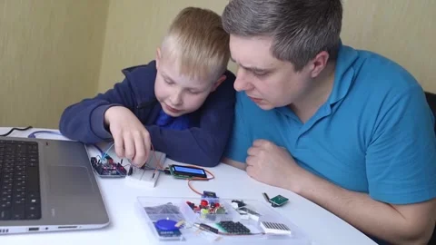 Programming for children. A teacher teaches a child at a robotics and IT school. Stock Footage 276207418