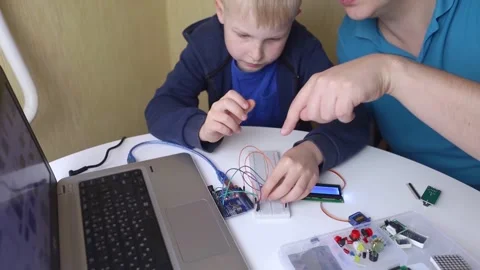 Programming for children. A teacher teaches a child at a robotics and IT school. Stock Footage 276207426