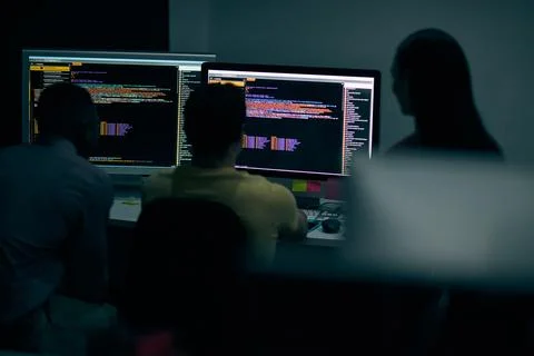 Programming, code and computer with business people in office at night for cyber 스톡 사진