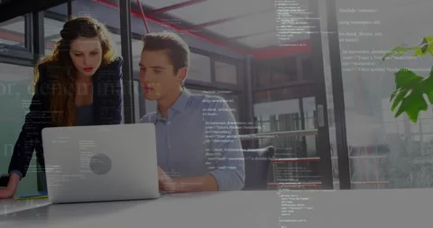 Programming code animation over business professionals working on laptop in Stock Footage 303739862