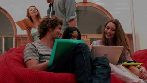 Programming code animation over diverse group of friends using laptops and Stock Footage 303685189