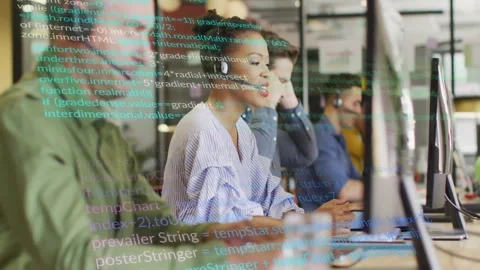 Programming code animation over diverse team working on computers in office Stock Footage 303878817