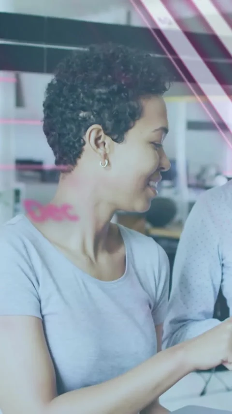 Programming code animation over two women discussing work in modern office Stock Footage 319416160
