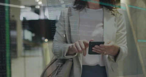 Programming code animation over woman using smartphone in modern office Stock Footage 306564486