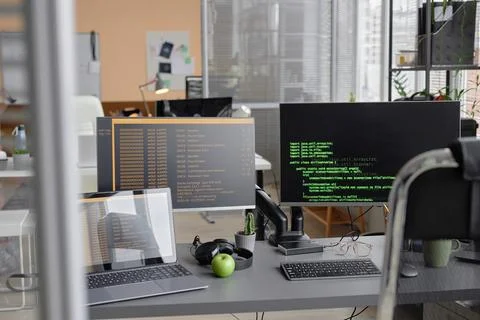 Programming Code on Computers in Empty Office Foto stock