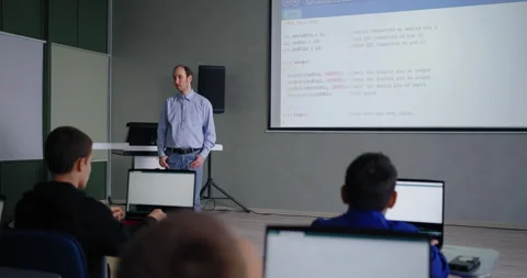 Programming Courses For Schoolers, Teens Boys Listening To Adult Male Teacher Stock Footage 280174613