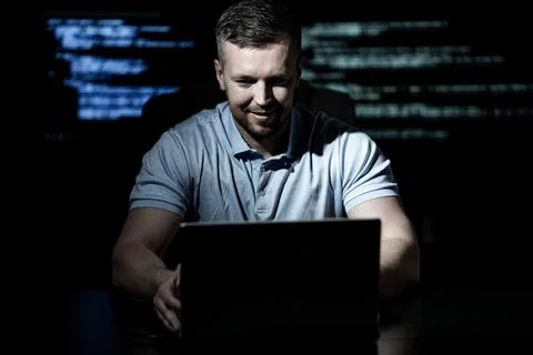 Programming in dark room shows cyber work. Programming on code screen builds Stock Photos